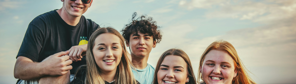 Young men and women smiling