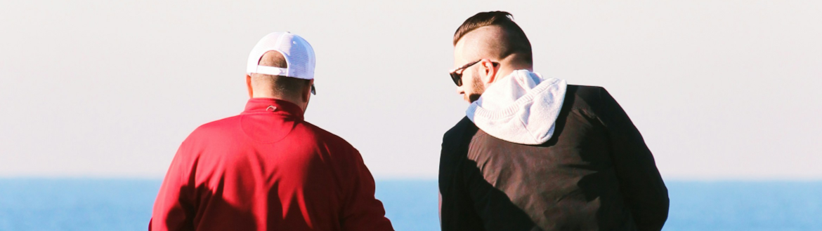 men talking at beach