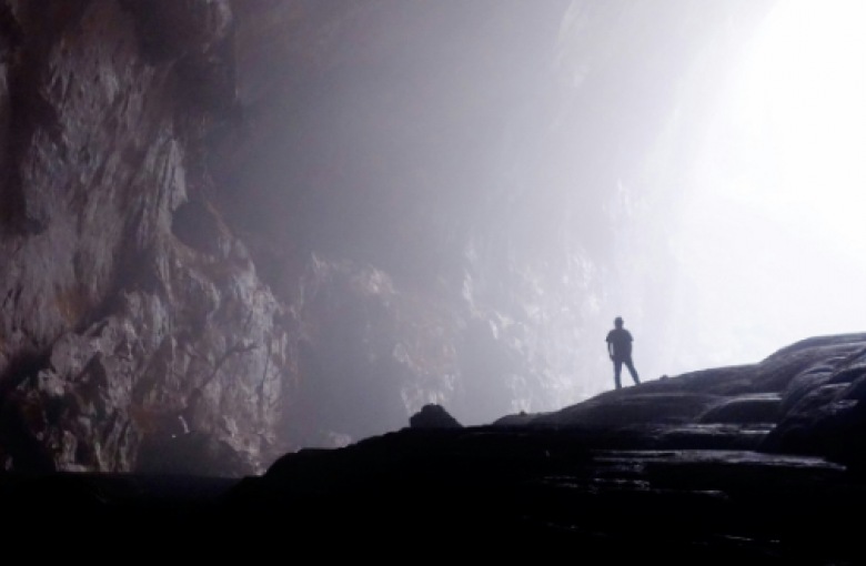 man standing in dark valley