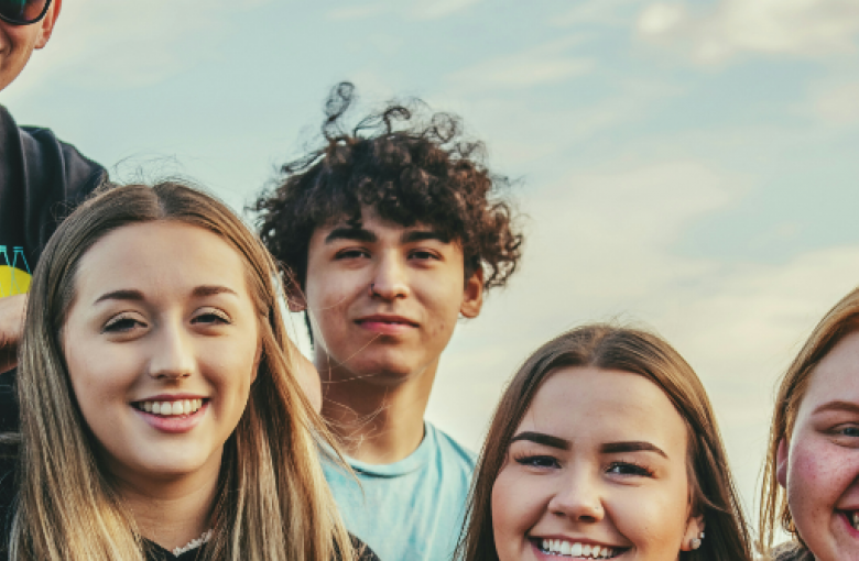 Young men and women smiling