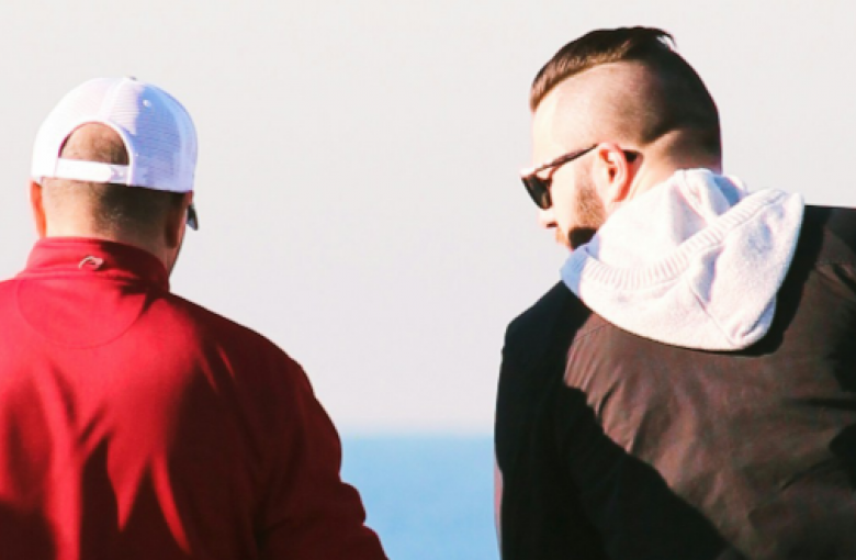 men talking at beach