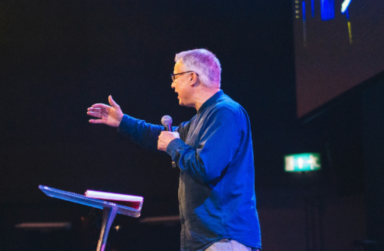 Man speaking to an unseen audience
