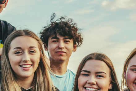 Young men and women smiling