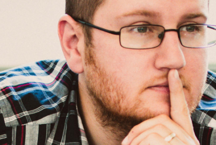 Man wearing glasses looking pensive