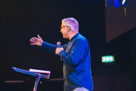 Man speaking to an unseen audience